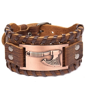 Close-up of brown leather Viking bracelet with bronze axe emblem and braided details
