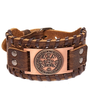 Detail of vintage brown leather bracelet with an antique bronze metal seal and rivets