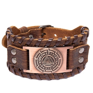 Vintage braided brown leather Viking bracelet with bronze rune totem plate on white background