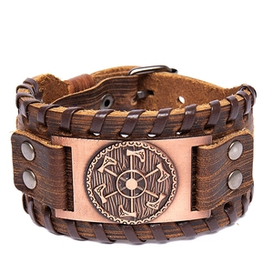 Vintage Viking leather bracelet with bronze axe medal on a white background