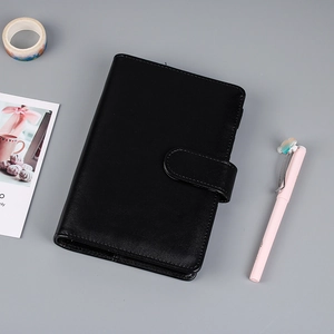 Detailed view of a black PU leather loose-leaf notebook with classic side buckle closure