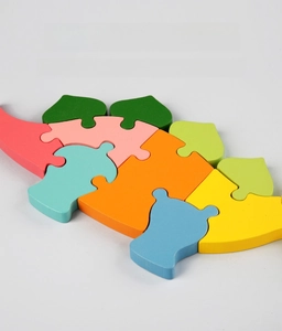 Macro detail of colorful wooden dinosaur puzzle blocks featuring safe water-based paint
