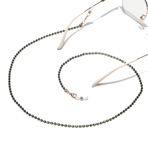 Detail of beaded eyewear chain with black and gold beads, lobster clasp and silicone loop