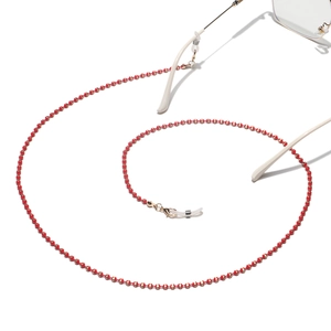 Detailed macro shot of red and gold beaded eyeglass chain with silicone loops