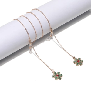 Rose gold eyewear chain featuring festive snowflake pendants with red and green accents
