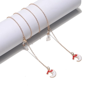 Detail of rose gold glasses chain with Christmas moon charm on white column