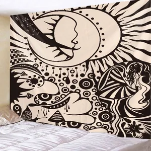 Detailed view of bohemian black and white sun and moon tapestry hanging on bedroom wall