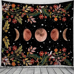 Detail of bohemian tapestry featuring moon phases and orange flowers on a dark starry background