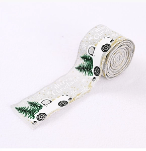 Detail of Christmas ribbon with vintage car and green pine tree prints on cream fabric