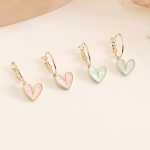 Minimalist heart-shaped drop earrings in pink and mint green with golden hoop finish