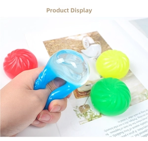 Hand squeezing a soft tomato-shaped stress ball to show its elastic squeeze function