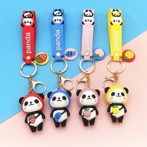 Close-up of four colorful silicone panda keychains with fruit charms and panda straps
