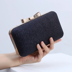 Sparkly pleated evening clutch bag with elegant gold bow clasp and sleek metallic frame