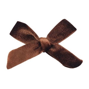 Detailed view of the dark chocolate velvet texture and classic knotted bow craftsmanship