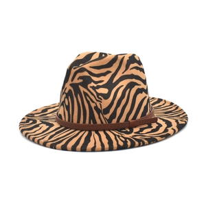 Detail of wide brim fedora hat with orange zebra animal print and woven decorative band