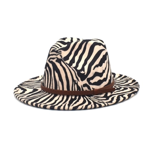 Detail of zebra pattern wool fedora hat featuring a stylish brown decorative band