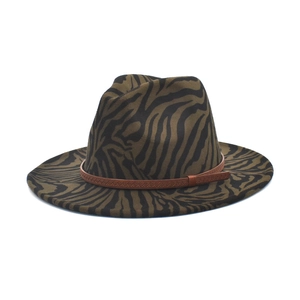 Detail of zebra print wool felt fedora hat featuring a brown woven leather hatband strap