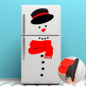 Close-up of magnetic snowman fridge stickers showing easy peel-off back for holiday decor