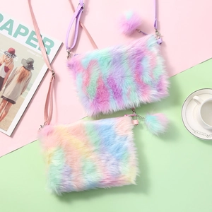Detail of soft macabre rainbow plush crossbody bag with colorful pompom charm