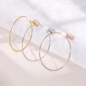 Three pairs of elegant hoop earrings with pearls and butterfly accents in gold and silver