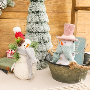 Christmas snowman dolls in knitted hats and scarves for festive home scene decoration