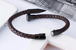Detail of coffee woven leather nail bracelet with black metal magnetic clasp closure