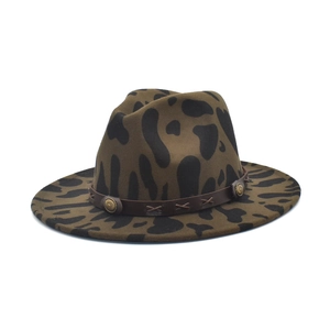 Detail of leopard print fedora with brown leather band and gold embossed metal buttons