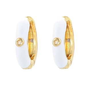 Detail of gold U-shaped huggie earrings with white enamel and centered cubic zirconia