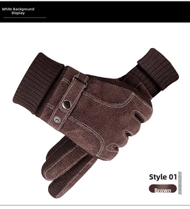 Detail of brown leather ski gloves with white decorative stitching and ribbed knit cuffs