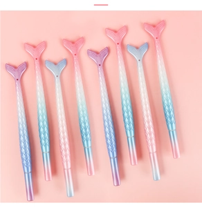 Close-up of eight gradient colored mermaid tail gel pens with detailed scale textures