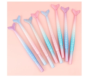 Detailed view of 8-piece mermaid tail pens in gradient pink and blue with scale texture