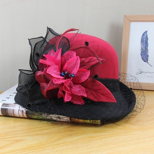 Detail of red wool felt hat with vintage mesh flower, feathers and bead embellishments