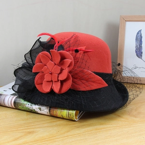 Detail of red wool felt flower and black mesh veil on vintage style bowler hat