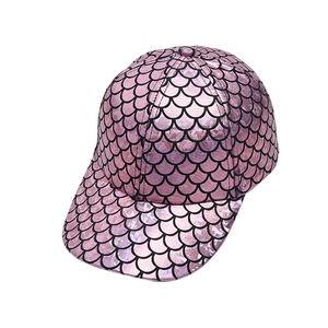 Close-up of pink fish scale baseball cap with metallic finish and black embossed pattern