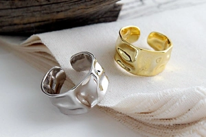 Detailed macro shot showing hammered texture on gold and silver irregular open rings