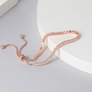 Rose gold tennis bracelet with 2.5mm square zircon stones on a geometric stand