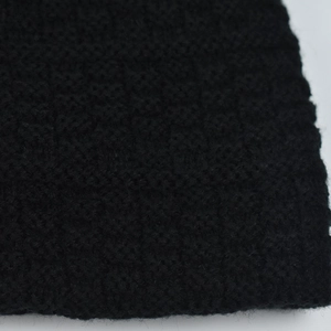 Macro shot of striped knit winter hat featuring premium black grid woven texture