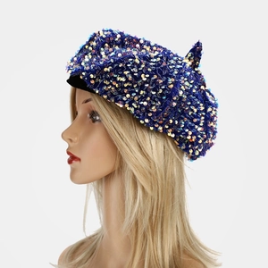 Detailed side view of dark blue velvet beret with colorful sparkling sequins decor
