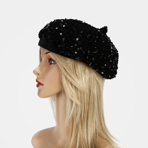 Close-up of a stylish black sequined beret hat with a reflective French-style finish