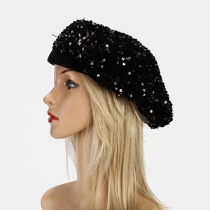 Detail of black sequin beret showing knit texture and shimmering circular sequins