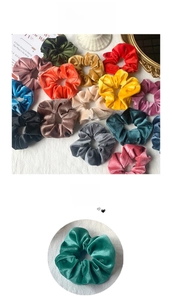 Close-up of vibrant velvet scrunchies collection in various colors with soft fabric texture