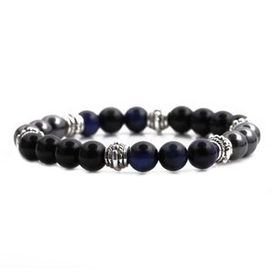 Detailed macro of 8mm blue tiger eye and hematite beaded bracelet with silver metal spacer