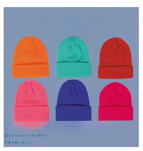 Detail showing various colors of ribbed knit beanies for kids in soft acrylic fabric