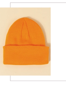 Detailed view of the thick bright orange knitted beanie featuring a wide folded cuff