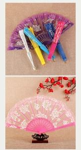 Detailed macro view of colorful lace folding fans in purple, white and pink for dancing
