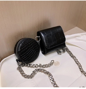 Detail of black crocodile texture mini bag and round purse with silver chain strap