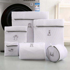 Macro view of white mesh laundry bags set with grey zippers and clothing icons