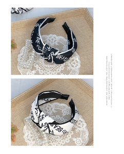 Detail of knot headband with contrast letter print in black and white fabric