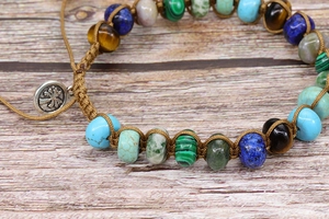 Detailed macro of handmade bohemian braided bracelet with colorful natural stone beads