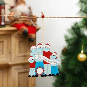 Christmas ornament featuring 5 family members in masks with the year we stayed home theme